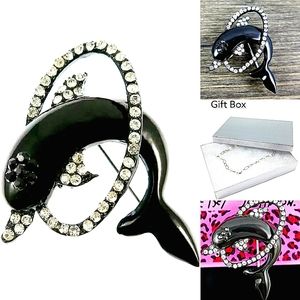 Silver black-and-white crystal dolphin brooch